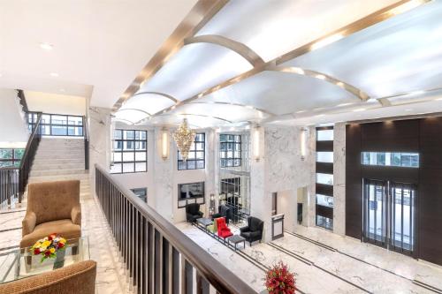 a living room with a staircase and a lobby at St Mark's Hotel Bengaluru, a member of Radisson Individuals in Bengaluru
