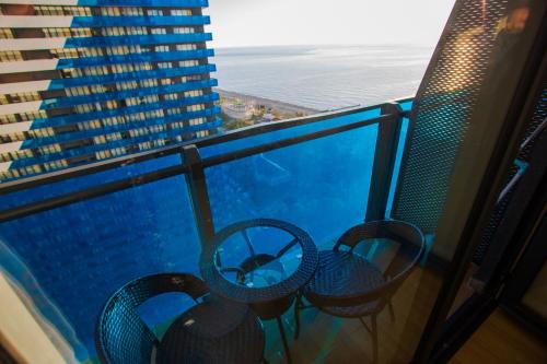 a balcony with chairs and a view of the ocean at Blue Horizon Suites in Orbi City Batumi in Angisa