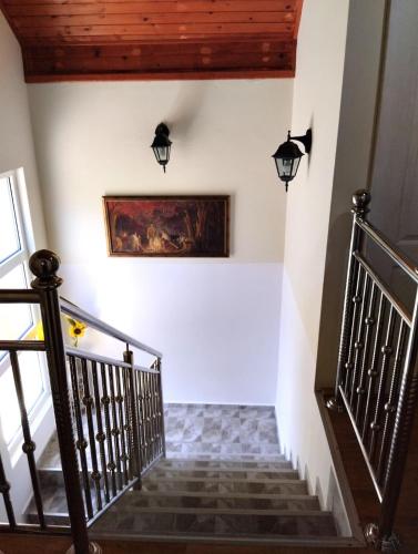 a staircase in a house with a painting on the wall at Vila ZLATNI BOR in Zlatibor