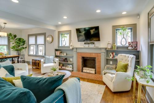 a living room with a couch and a fireplace at Renovated Lubbock Home - Walk to Texas Tech! in Lubbock