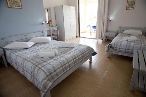 a bedroom with two beds and a window at olivensun apartment 4 in Gythio