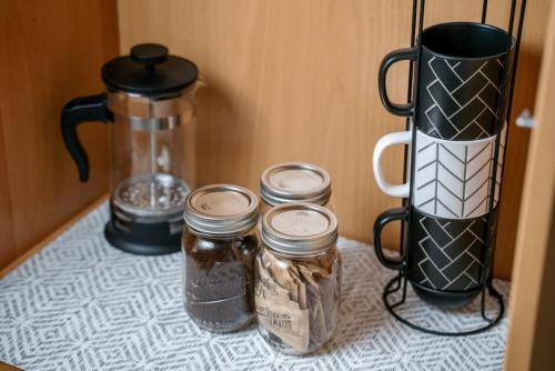 a counter with four jars of food and a blender at Modern 2BR Mesa Condo in Central Location with Pool Access in Mesa