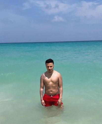 a man standing in the water in the ocean at Hostel bunker Peruano in Playa Blanca