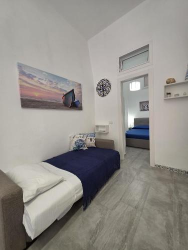 a bedroom with a bed and a painting on the wall at Giomasue' in Porticello