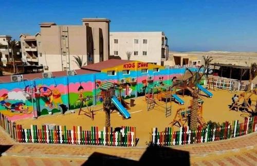 a playground with a mural on the wall at Tavera Ras Sudr in Makman