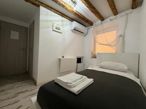 a bedroom with a bed with two towels on it at Lighthouse.Izola in Izola