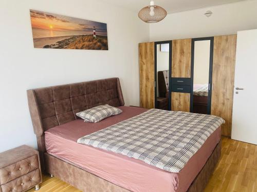 a bedroom with a bed and a picture on the wall at InterAssist 15 in Heidelberg