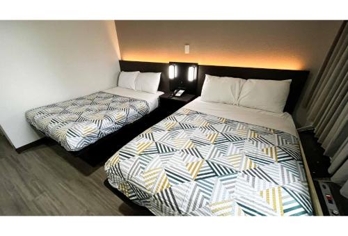 a hotel room with two beds in a room at Studio 6 Lafayette, LA I-10 & I-49 N in Lafayette