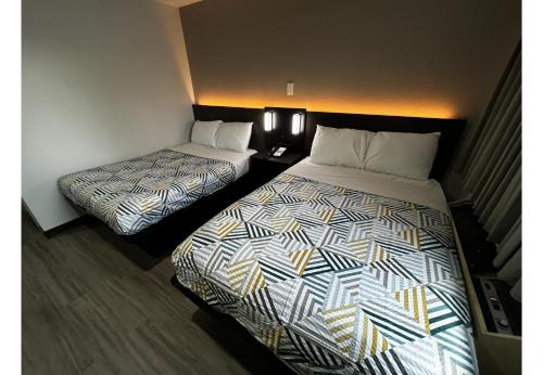 a hotel room with two beds in a room at Studio 6 Lafayette, LA I-10 & I-49 N in Lafayette