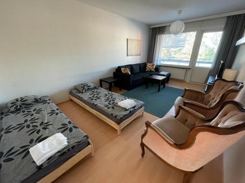 a living room with a bed and a couch at Familyfriendly, charming apartment 3 km to centre in Porvoo
