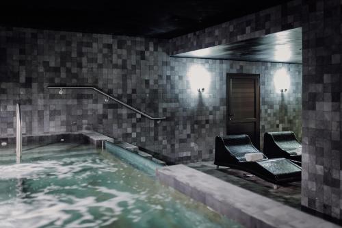 a swimming pool with two chairs in the water at Grand Brizo Bel Air in Buenos Aires