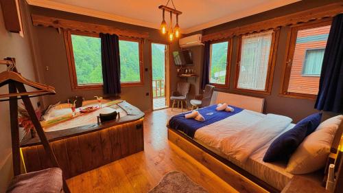 a bedroom with a large bed and a bath tub at River Deluxe Botıque in Çamlıhemşin