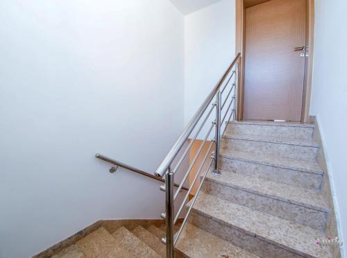 a set of stairs with a wooden door at Apartment Elle in Čitluk