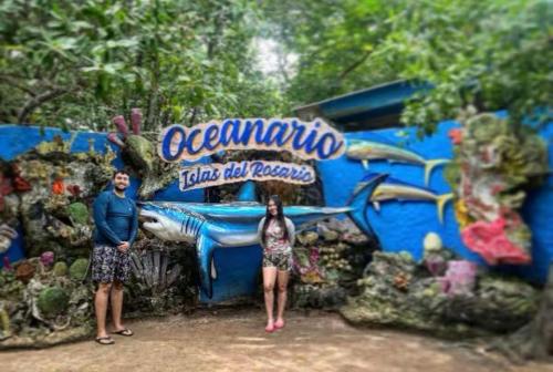 a man and a woman standing in front of a lego aquarium at Hostel bunker Peruano in Playa Blanca