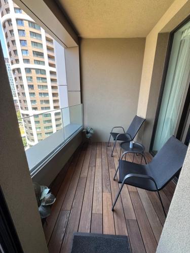 an empty room with two chairs and two windows at Sky park by Zaha Hadid- modern stay with Garage in Nivy