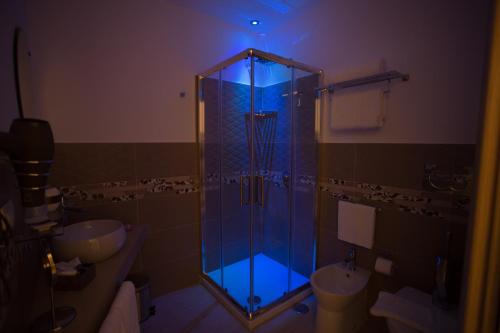 a bathroom with a shower with a blue light at Relais Villa Anna in Anacapri