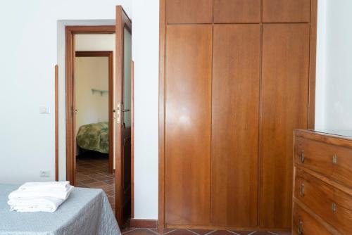 a bedroom with a wooden closet and a bed at Villa Alloro in Massa Lubrense