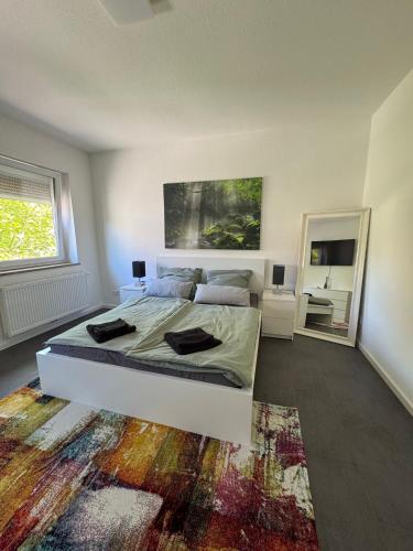 a bedroom with a large bed and a rug at Modernes Zimmer am Campus 3 mit Gemeinschaftsbad in Villingen-Schwenningen
