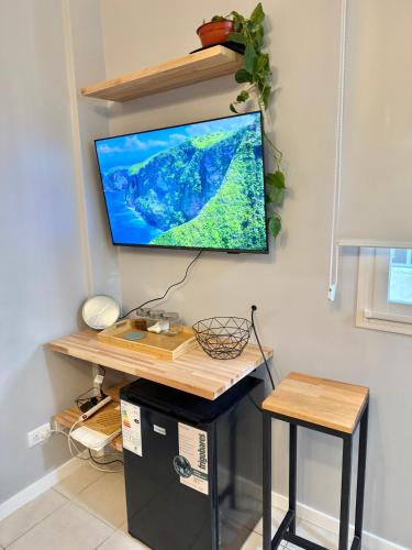 a flat screen tv hanging on a wall at Blue Ocean in Mar del Plata