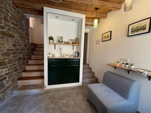 a living room with a green door and stairs at Lighthouse.Izola in Izola