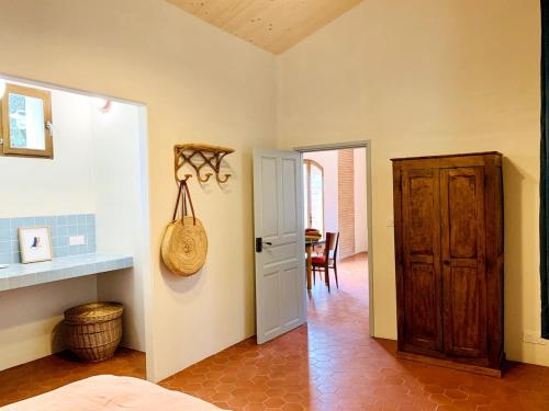 a room with a bed and a door and a table at Mas Saint Michel in Vivès