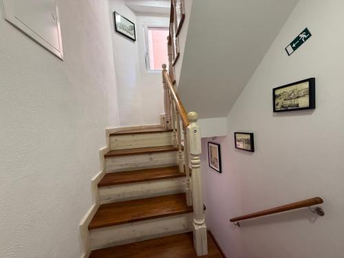 a staircase with wooden floors and white walls at Lighthouse.Izola in Izola