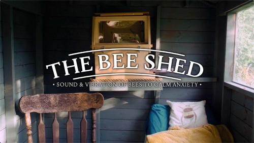 a sign that says the bee shed in a room with a chair at Unplug & Reconnect, Romantic Retreat with Hot Tub in Yarpole