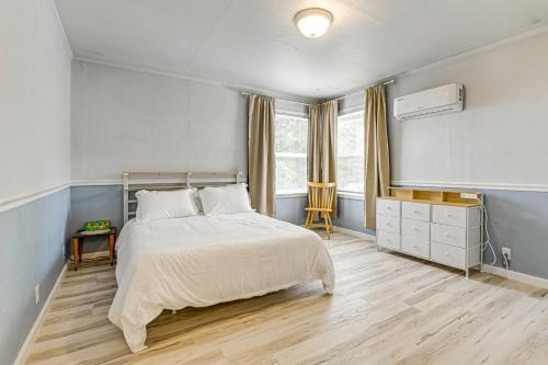 a bedroom with a large bed and a window at Walk to Beach Cozy Home with Deck in Smith River! in Smith River