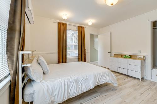 a bedroom with a white bed and a window at Walk to Beach Cozy Home with Deck in Smith River! in Smith River