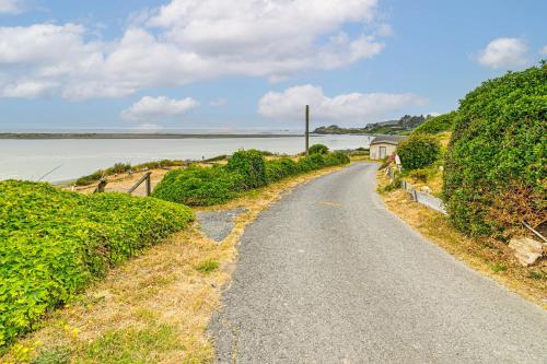 a road next to a body of water at Walk to Beach Cozy Home with Deck in Smith River! in Smith River