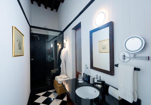 a bathroom with a sink and a mirror and a shower at Antiguo Molino de San Jerónimo in Mexico City