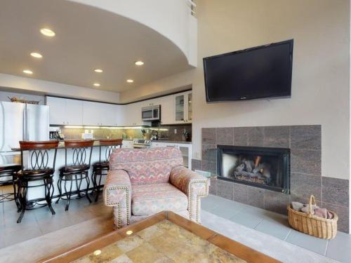 a living room with a couch and a fireplace at Montaneros in Vail in Vail
