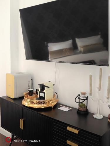 a black dresser with a toaster and a toaster at Royal Lux in Sagunto