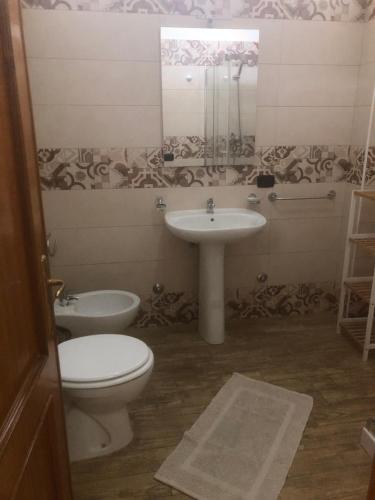 a bathroom with a toilet and a sink at Monolocali Angelica in Porto Cesareo