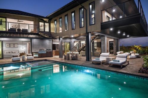 an exterior view of a house with a swimming pool at Hale O Ka Nene in Koloa