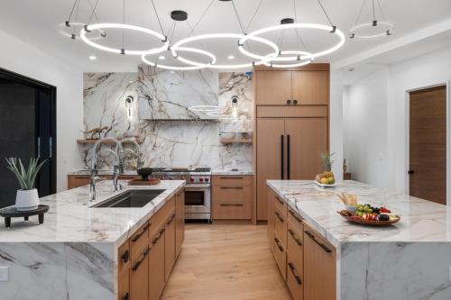 a kitchen with a large island with marble counter tops at Hale O Ka Nene in Koloa