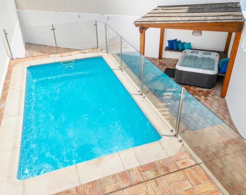 a swimming pool in the middle of a house at Villa Casablanca by Algarve Vacation in Portimão