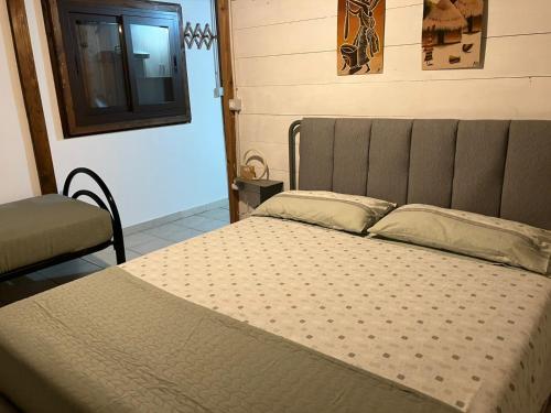 a large bed in a room with a window at Ricciardulli Rooms in Policoro