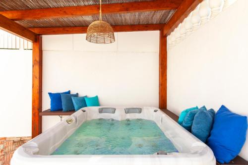 a bath tub in a room with blue pillows at Villa Casablanca by Algarve Vacation in Portimão