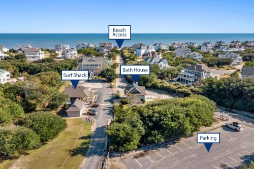 an aerial view of a neighborhood with houses and the ocean at Sailors Cove in Corolla
