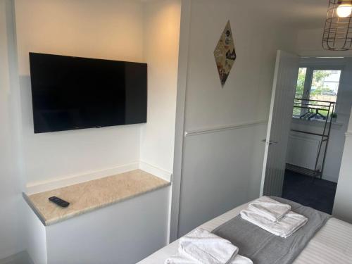 a bedroom with a flat screen tv on the wall at NEW - 3 Bedroom House in East Kilbride in East Kilbride