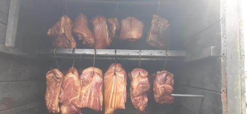 a bunch of bacon and meat hanging from an oven at Apartmány Kroměřížsko in Hulín