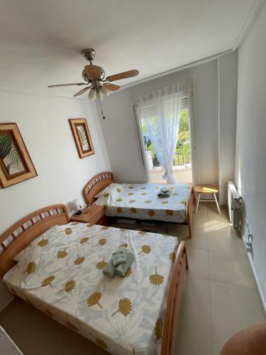 a bedroom with two beds and a window at Arty Apartment - La Torre Golf Resort in Torre-Pacheco