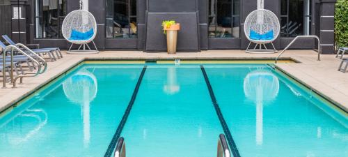 a swimming pool with two chairs at Noho Haven 2 bed Apt with FREE Parking in North Hollywood
