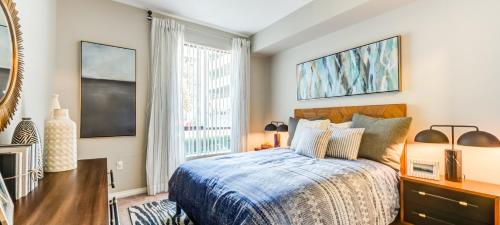 a bedroom with a bed and a large window at Noho Haven 2 bed Apt with FREE Parking in North Hollywood