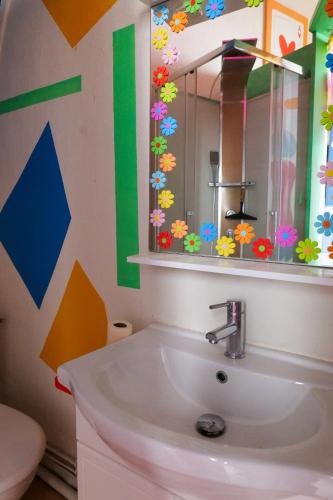 une salle de bain avec un lavabo et un miroir dans l'établissement Studette pop art Angers - 2 personnes, à Angers