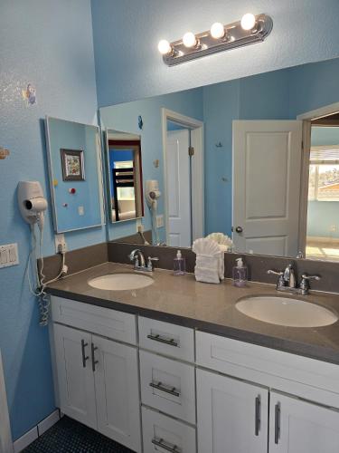 a bathroom with two sinks and a large mirror at F-33 Walts Place in Anaheim