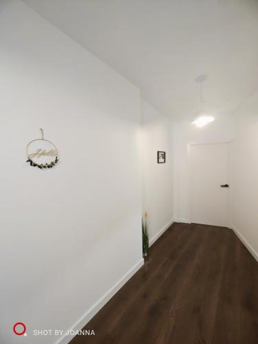 an empty living room with white walls and wood floors at Royal Lux in Sagunto
