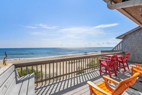 a balcony with chairs and tables and the beach at The Lily Pad in Nags Head