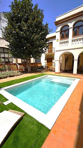 a swimming pool in the yard of a house at Historic House at Can Quintana by Casa de Elena in Pineda de Mar
